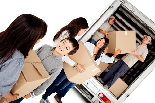 Moving team handling belongings safely with protective equipment in Kingsbury