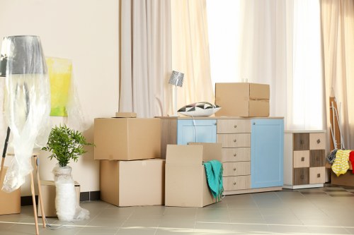 A green moving van with recycled packing materials during a Kingsbury removal
