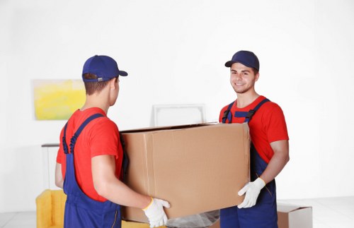 Professional movers transporting boxed household items for a Kingsbury home move