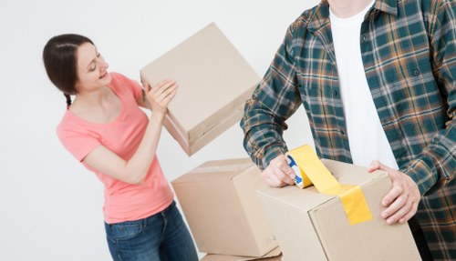 Removal van and moving team in a Kingsbury residential street