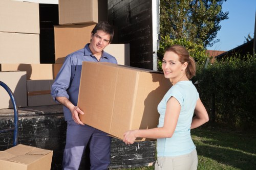 Man with van team protecting property while carrying items indoors