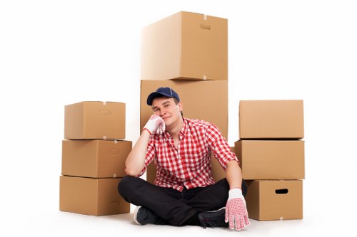 Removal team transporting boxes and furniture in Kingsbury